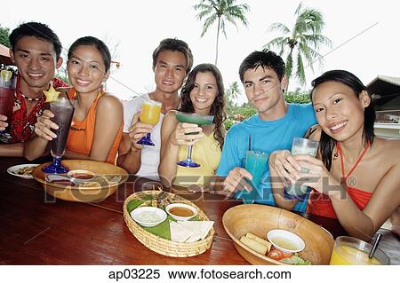 Couples with drinks at beach bar View Large Photo Image Stock Photography - Couples with drinks at beach bar . Fotosearch