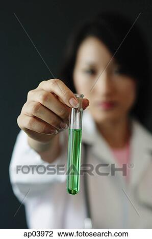 Doctor holding test tube filled with green liquid, selective focus View Large Photo Image Stock Image - Doctor holding test tube filled with green liquid, selective focus . Fotosearch