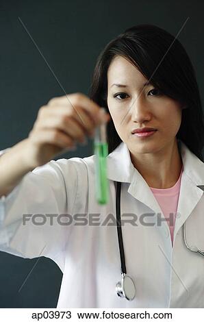 Doctor holding test tube View Large Photo Image Stock Image - Doctor holding test tube . Fotosearch