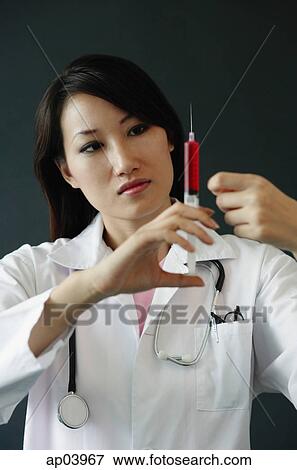 Doctor preparing syringe View Large Photo Image Stock Photo - Doctor preparing syringe . Fotosearch