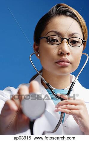 Stock Photography - Doctor using stethoscope. Fotosearch
