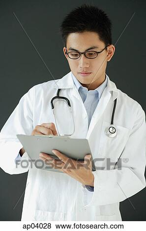 Doctor writing on clipboard View Large Photo Image Stock Photo - Doctor writing on clipboard. Fotosearch