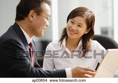 Executives having a discussion View Large Photo Image Picture - Executives having a discussion . Fotosearch