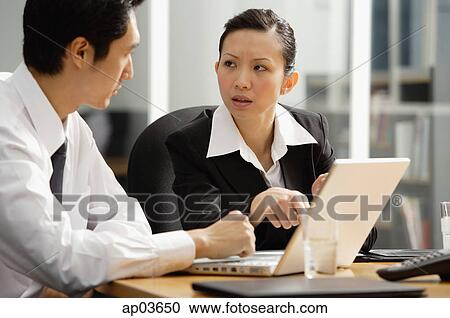Executives having a discussion View Large Photo Image Stock Image - Executives having a discussion. Fotosearch