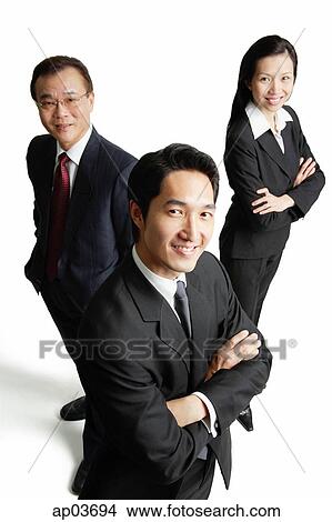 Executives looking at camera, smiling View Large Photo Image Picture - Executives looking at camera, smiling. Fotosearch