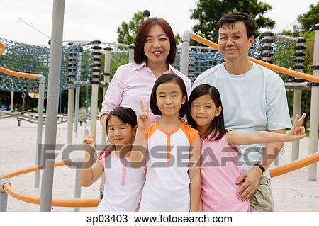 Family at playground, smiling at camera View Large Photo Image Stock Image - Family at playground, smiling at camera . Fotosearch