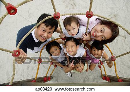 Family at playground, smiling at camera, high angle view View Large Photo Image Stock Image - Family at playground, smiling at camera, high angle view . Fotosearch