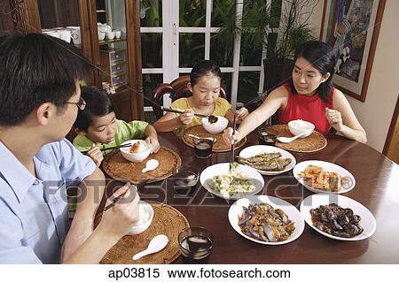 Family of four eating at home View Large Photo Image Stock Photography - Family of four eating at home . Fotosearch