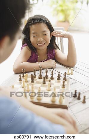 Father and daughter playing a game of chess View Large Photo Image Stock Image - Father and daughter playing a game of chess . Fotosearch