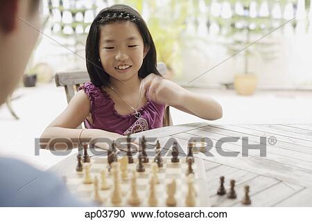 Father and daughter playing chess View Large Photo Image Stock Image - Father and daughter playing chess . Fotosearch