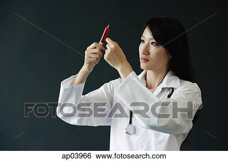 Female doctor preparing syringe View Large Photo Image Stock Photograph - Female doctor preparing syringe . Fotosearch