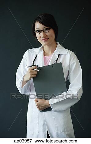 Female doctor smiling at camera View Large Photo Image Stock Photo - Female doctor smiling at camera. Fotosearch