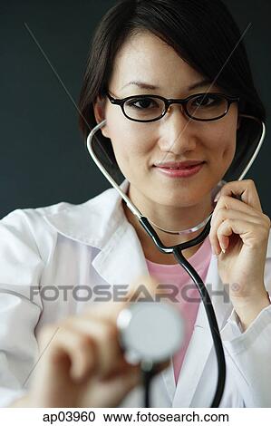 Female doctor using stethoscope View Large Photo Image Stock Image - Female doctor using stethoscope . Fotosearch