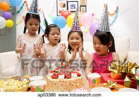 Stock Photograph - Four girls celebrating birthday . Fotosearch
