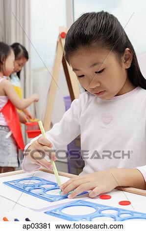 Girl drawing with stencil View Large Photo Image Stock Image - Girl drawing with stencil. Fotosearch