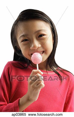Stock Photography - Girl eating lollipop. Fotosearch