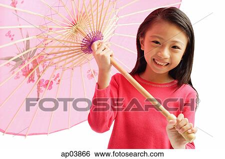 Girl holding pink umbrella View Large Photo Image Stock Photograph - Girl holding pink umbrella. Fotosearch