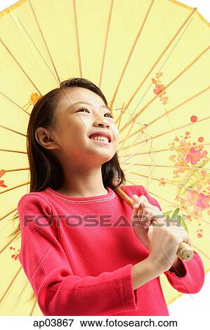 Stock Photo - Girl holding yellow umbrella . Fotosearch