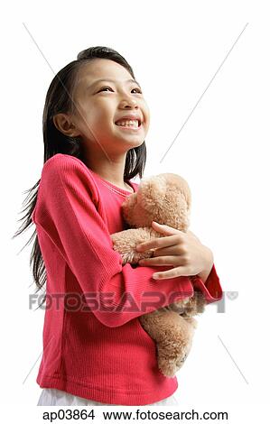 Girl hugging teddy bear View Large Photo Image Picture - Girl hugging teddy bear. Fotosearch