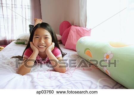 Girl in bedroom, hands on chin, looking at camera View Large Photo Image Stock Image - Girl in bedroom, hands on chin, looking at camera . Fotosearch