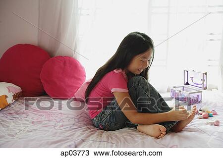 Girl in bedroom, painting toenails, side view View Large Photo Image Stock Image - Girl in bedroom, painting toenails, side view. Fotosearch
