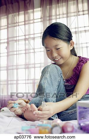 Girl in purple top sitting on bed, painting toenails View Large Photo Image Stock Photograph - Girl in purple top sitting on bed, painting toenails . Fotosearch