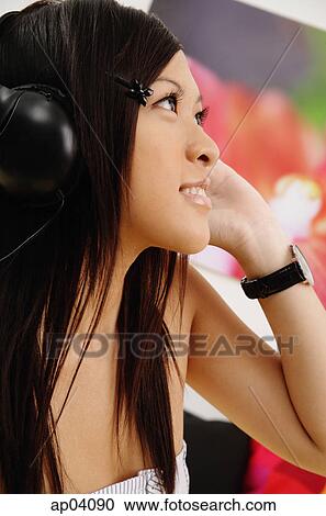Girl listening to headphones, side view View Large Photo Image Stock Image - Girl listening to headphones, side view . Fotosearch