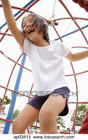 Stock Photography - Girl on jungle gym, laughing . Fotosearch