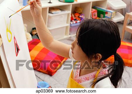 Girl painting on easel View Large Photo Image Stock Photo - Girl painting on easel. Fotosearch