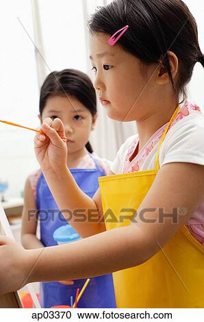 Girl with paintbrush, another girl standing next to her View Large Photo Image Stock Image - Girl with paintbrush, another girl standing next to her . Fotosearch