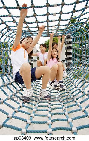 Girls crawling through net tunnel in playground View Large Photo Image Stock Photo - Girls crawling through net tunnel in playground . Fotosearch