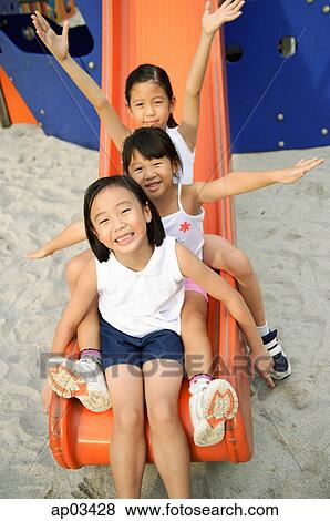 Stock Photo - Girls on a slide. Fotosearch