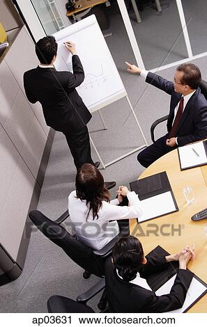 Group having a business meeting, man writing on flipchart View Large Photo Image Stock Image - Group having a business meeting, man writing on flipchart . Fotosearch
