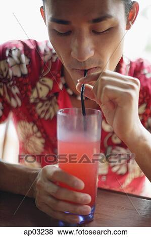 Man in floral shirt, drinking cocktail View Large Photo Image Stock Photo - Man in floral shirt, drinking cocktail . Fotosearch