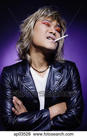 Man in leather jacket, wearing make-up, cigarette in mouth View Large Photo Image Stock Photo - Man in leather jacket, wearing make-up, cigarette in mouth. Fotosearch
