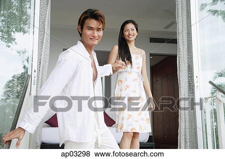 Man looking at camera, holding womans hand View Large Photo Image Stock Photo - Man looking at camera, holding womans hand. Fotosearch