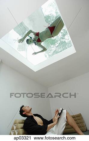 Man looking at woman in swimming pool through the skylight View Large Photo Image Stock Image - Man looking at woman in swimming pool through the skylight . Fotosearch