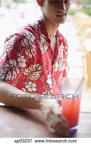 Man sitting at bar counter, holding drink, selective focus View Large Photo Image Stock Photo - Man sitting at bar counter, holding drink, selective focus . Fotosearch