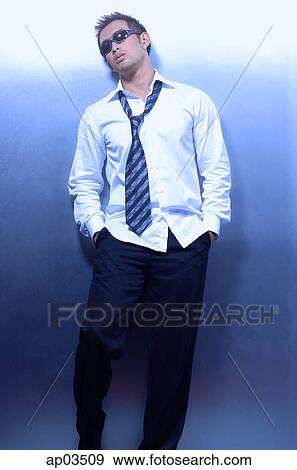 Man wearing shirt, tie and sunglasses, leaning on wall View Large Photo Image Stock Photo - Man wearing shirt, tie and sunglasses, leaning on wall. Fotosearch