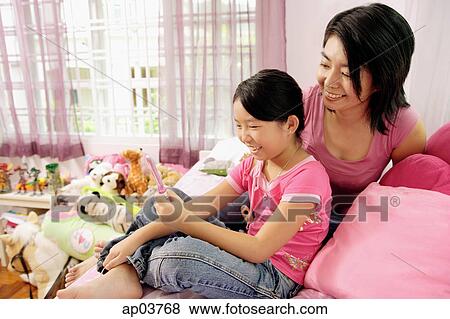 Mother and daughter in bedroom, daughter looking into mirror View Large Photo Image Stock Photo - Mother and daughter in bedroom, daughter looking into mirror. Fotosearch