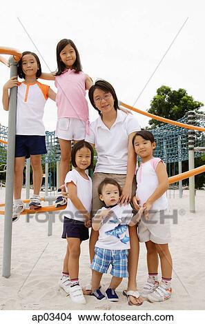 Siblings at playground, smiling at camera View Large Photo Image Picture - Siblings at playground, smiling at camera . Fotosearch