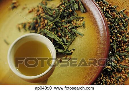 Still life of tea cup on tray, tea leaves scattered around View Large Photo Image Stock Image - Still life of tea cup on tray, tea leaves scattered around. Fotosearch