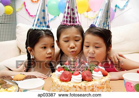 Three girls celebrating a birthday View Large Photo Image Stock Photo - Three girls celebrating a birthday . Fotosearch