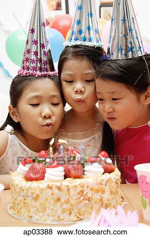 Three girls celebrating a birthday, blowing birthday candles View Large Photo Image Stock Photo - Three girls celebrating a birthday, blowing birthday candles. Fotosearch