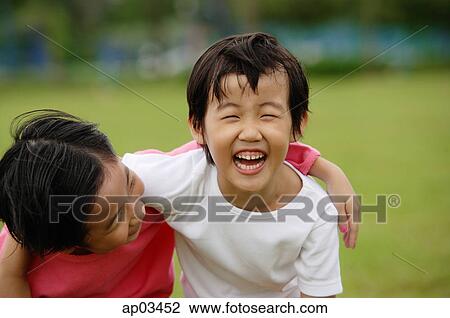 Two girls with arms around each other, laughing View Large Photo Image Stock Image - Two girls with arms around each other, laughing . Fotosearch