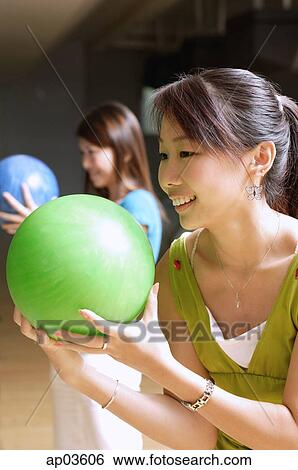 Two women with bowling balls, preparing to bowl View Large Photo Image Stock Photograph - Two women with bowling balls, preparing to bowl . Fotosearch