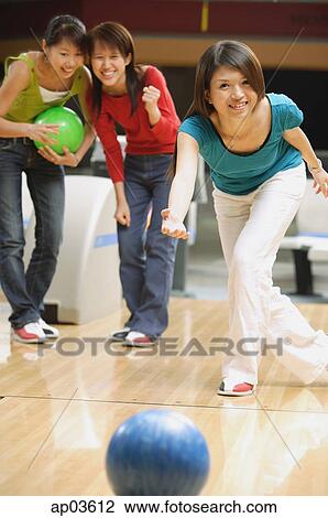 Woman bowling, friends behind her, watching View Large Photo Image Stock Image - Woman bowling, friends behind her, watching . Fotosearch