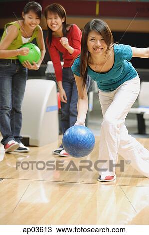 Woman bowling, friends behind her, watching View Large Photo Image Stock Image - Woman bowling, friends behind her, watching . Fotosearch