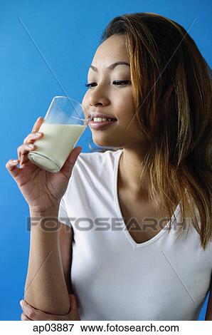 Stock Photo - Woman drinking a glass of milk. Fotosearch