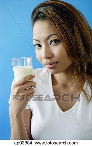 Picture - Woman holding a glass of milk. Fotosearch